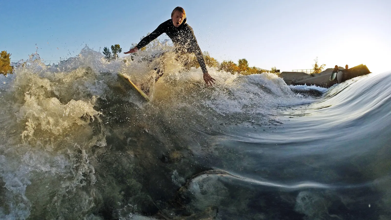 A river surfer riding the standing wave at the Boise Whitewater Park
