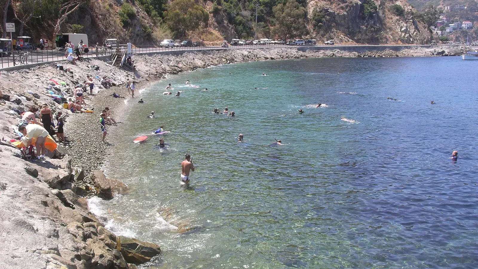 Snorkelers in the clear, rocky water of Lover's Cove near Avalon