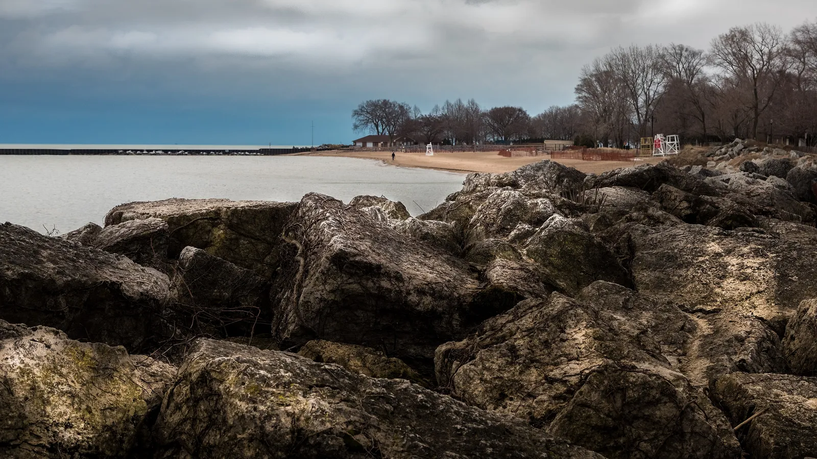 Limestone blocks on the Evanston lakefront at Greenwood Street Beach, with a breakwater stretching into Lake Michigan