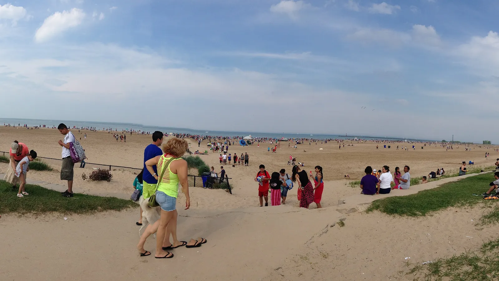 Beachgoers on the wide sand at Montrose Beach on a summer day