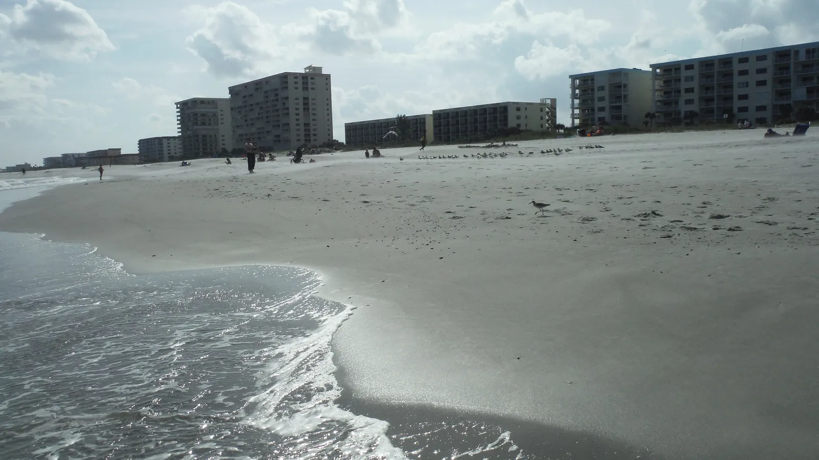 Small waves washing up on the wide sand beach at Cocoa Beach