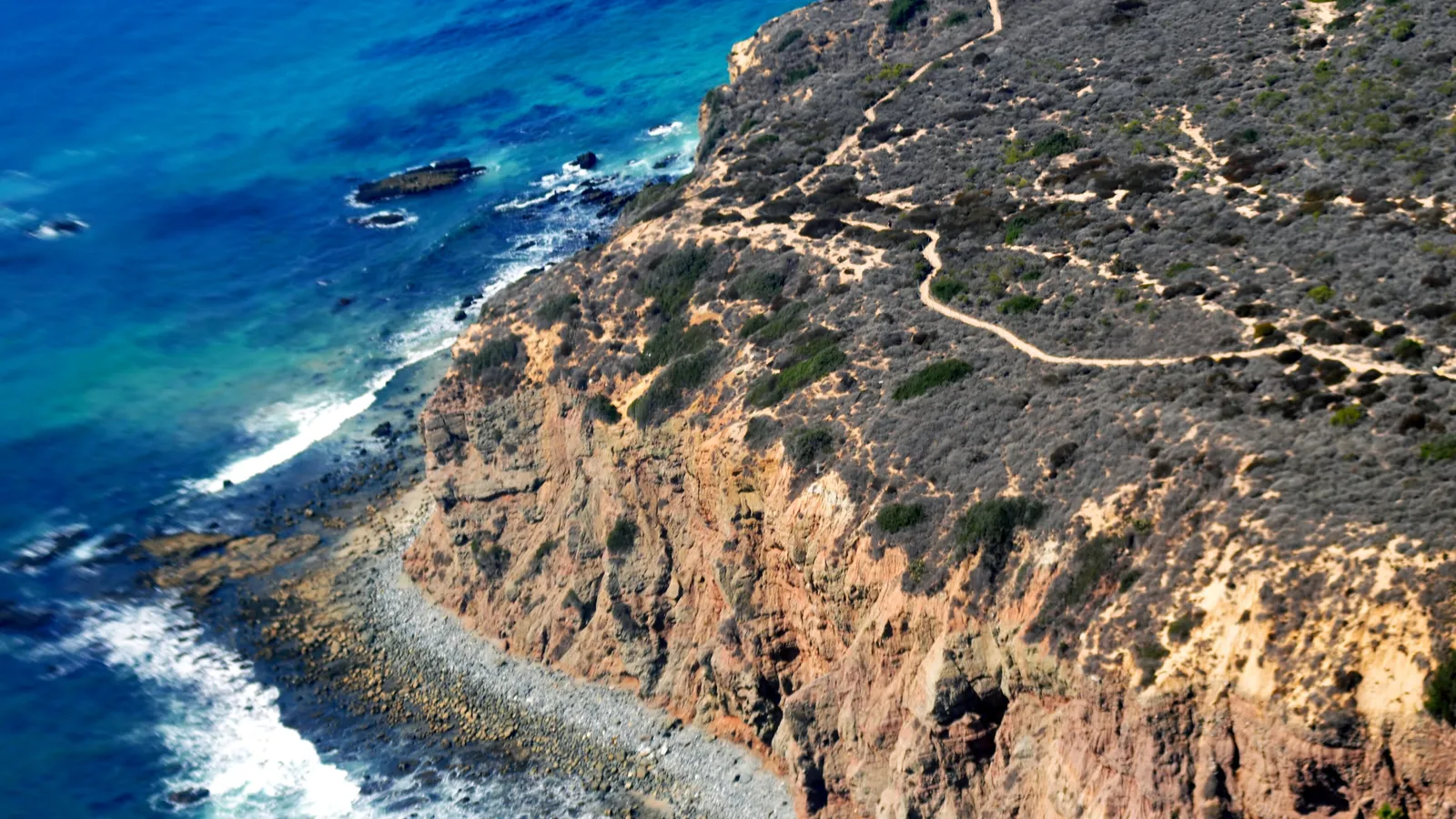 The cliffs of the Dana Point headland dropping to the rocky shoreline
