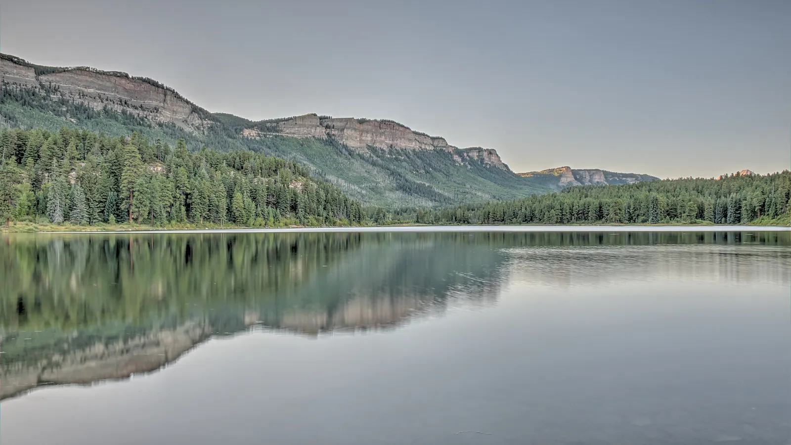 Still water on Haviland Lake reflecting the Hermosa Cliffs