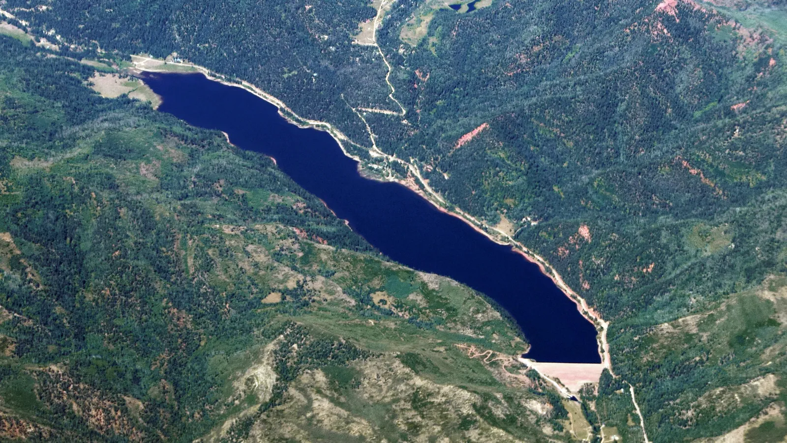Aerial view of Lemon Reservoir and its dam in a forested valley northeast of Durango