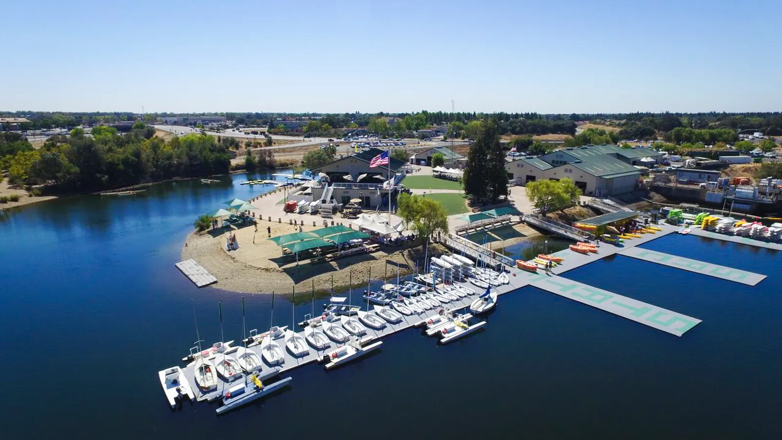 Aerial view of the Sacramento State Aquatic Center docks and beach on Lake Natoma