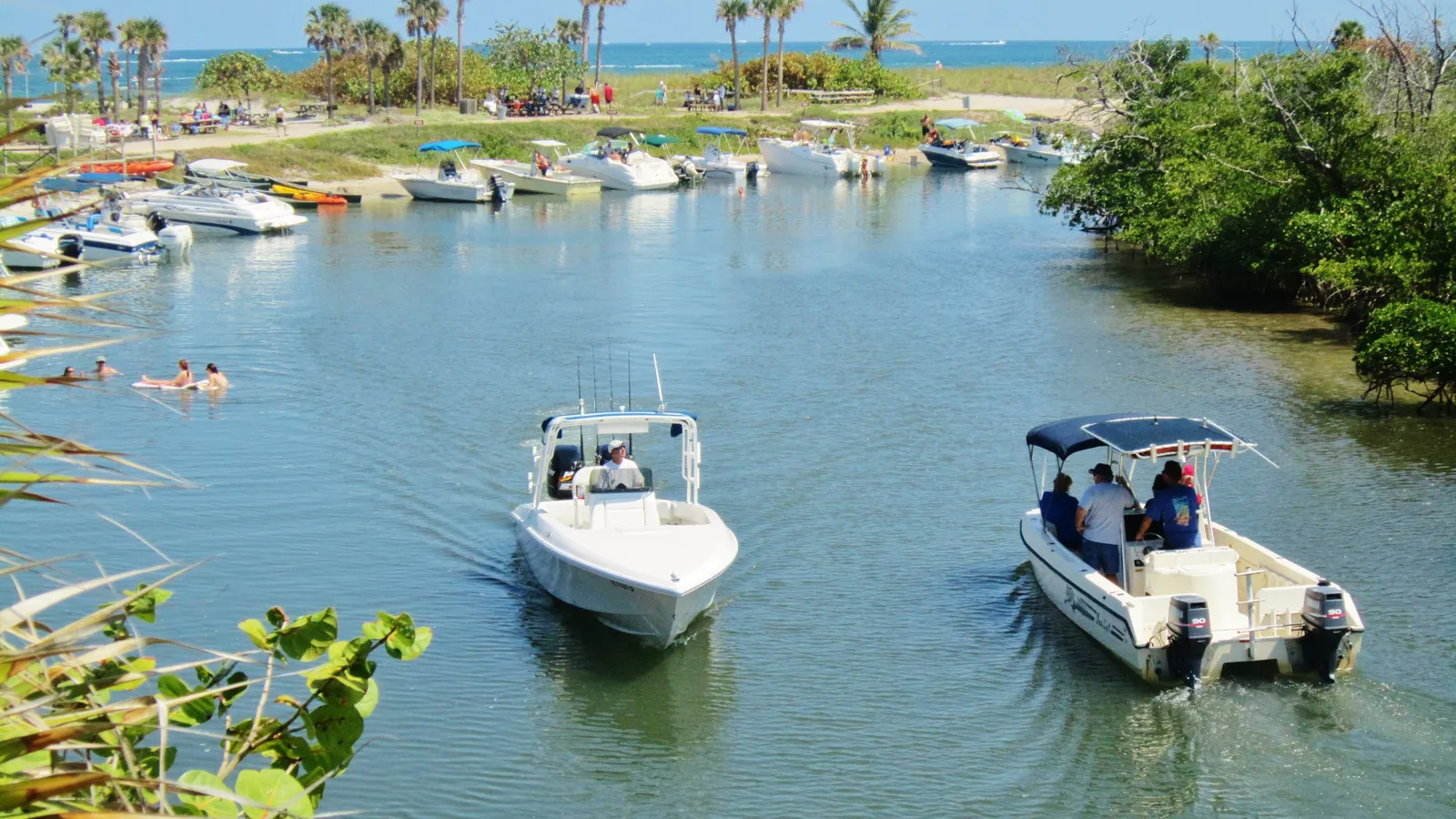 Boats and swimmers in the lagoon at the north end of Dr. Von D. Mizell-Eula Johnson State Park