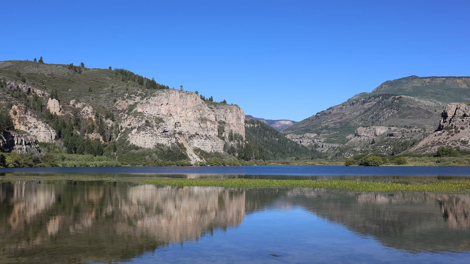 Rocky cliffs reflected in still water at Sweetwater Lake