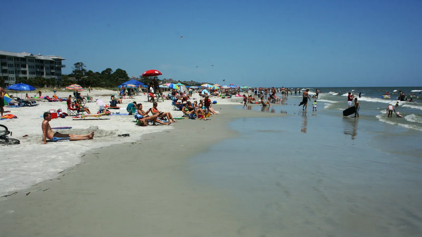 A busy summer day on the wide, flat Atlantic beach at Hilton Head Island