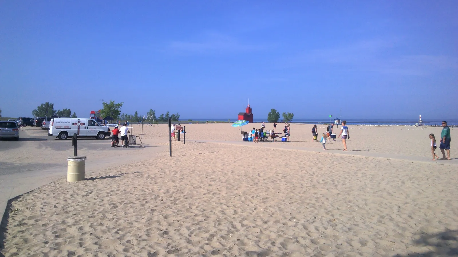 The Lake Michigan beach at Holland State Park, with Big Red lighthouse in the distance