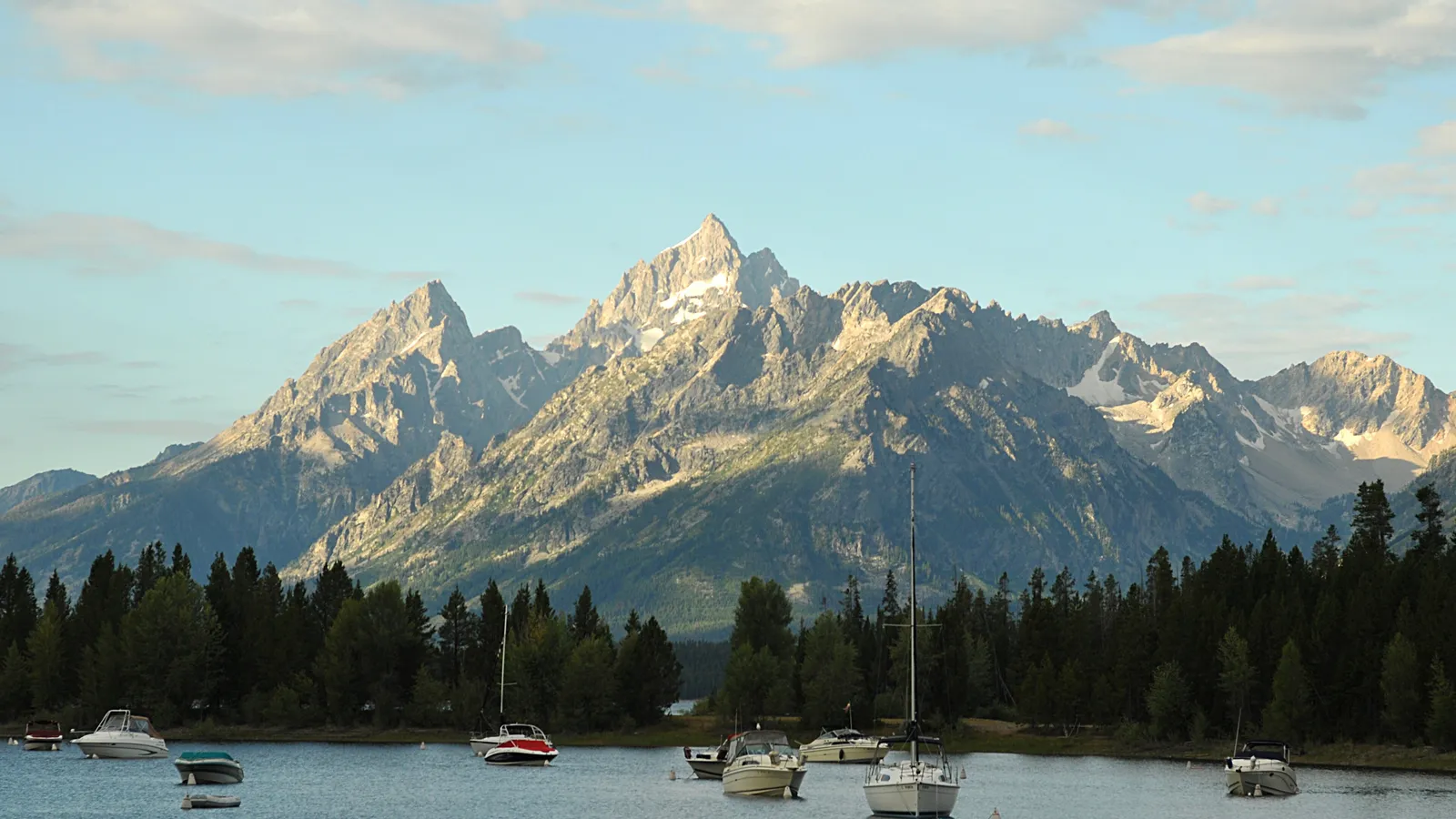 Boats moored in Colter Bay on Jackson Lake with the Teton Range behind