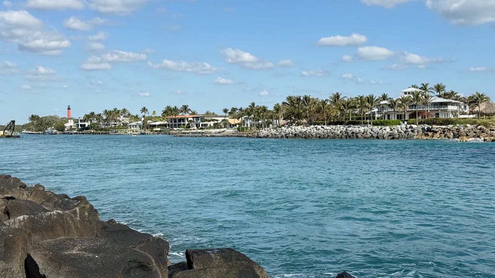 Clear blue water of Jupiter Inlet seen from the rocks at DuBois Park, looking west