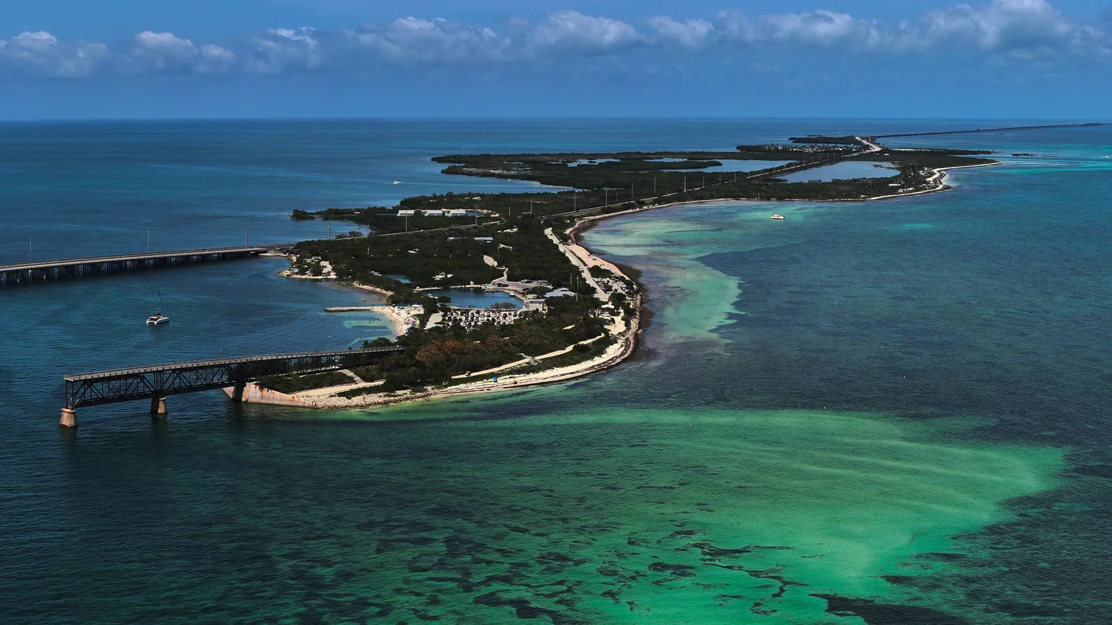 Aerial view of Bahia Honda Key, its old railroad bridge and the surrounding shallow green water