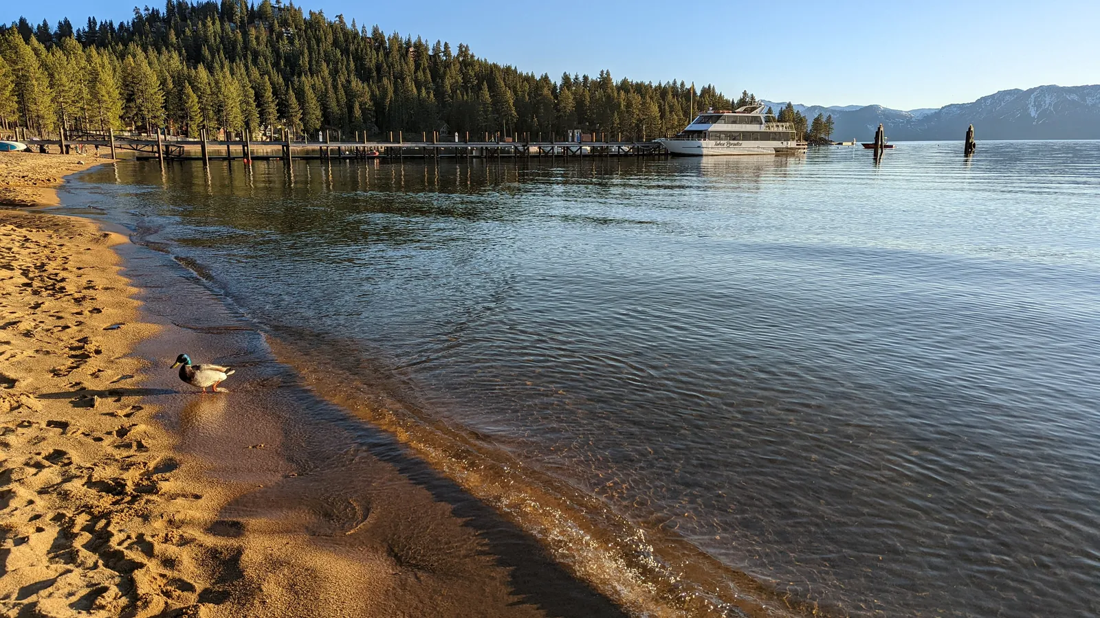 Calm morning water and the long pier at Zephyr Cove on Lake Tahoe's Nevada shore