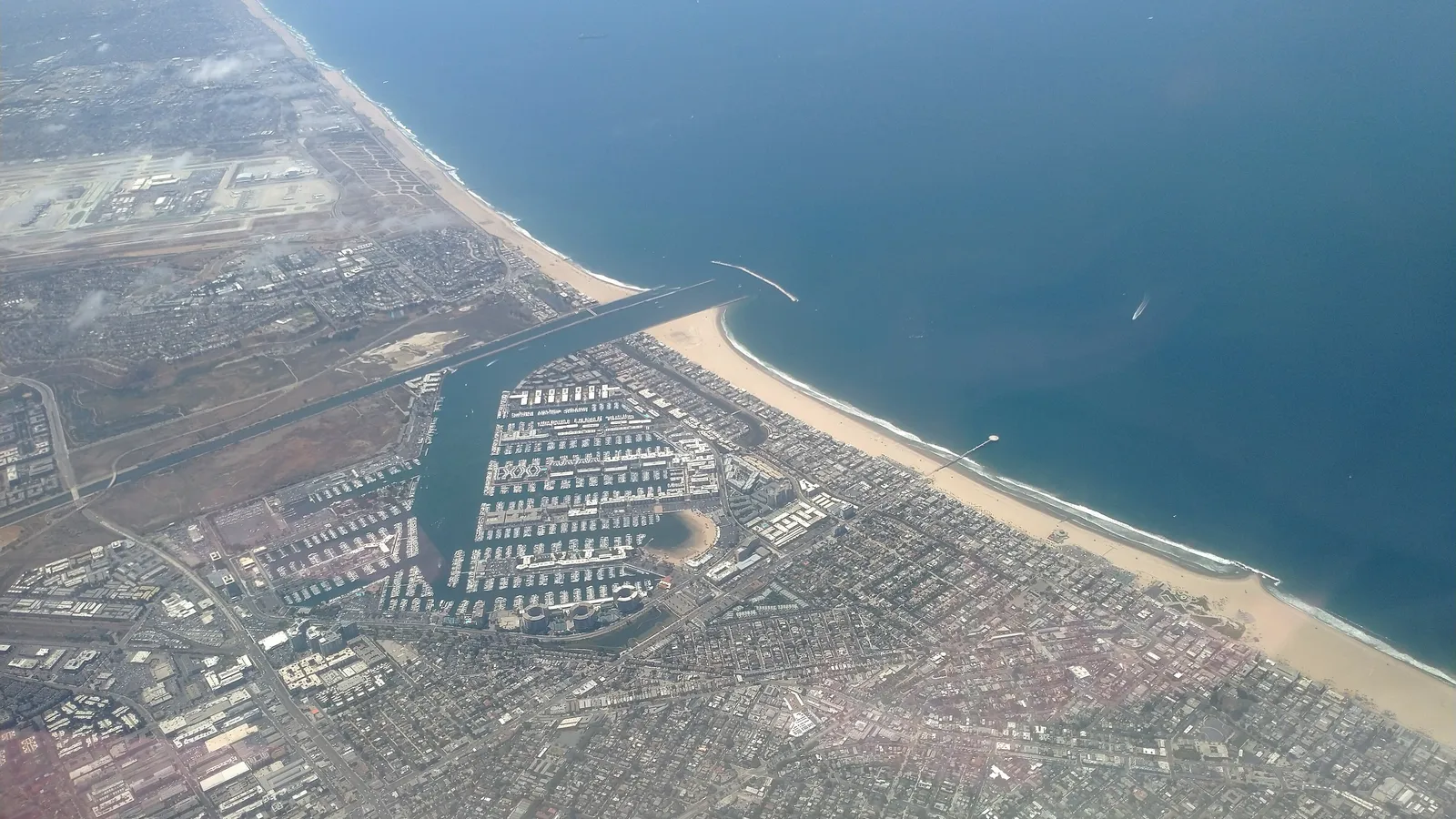 Aerial view of Marina del Rey's harbor and breakwater beside Venice Beach