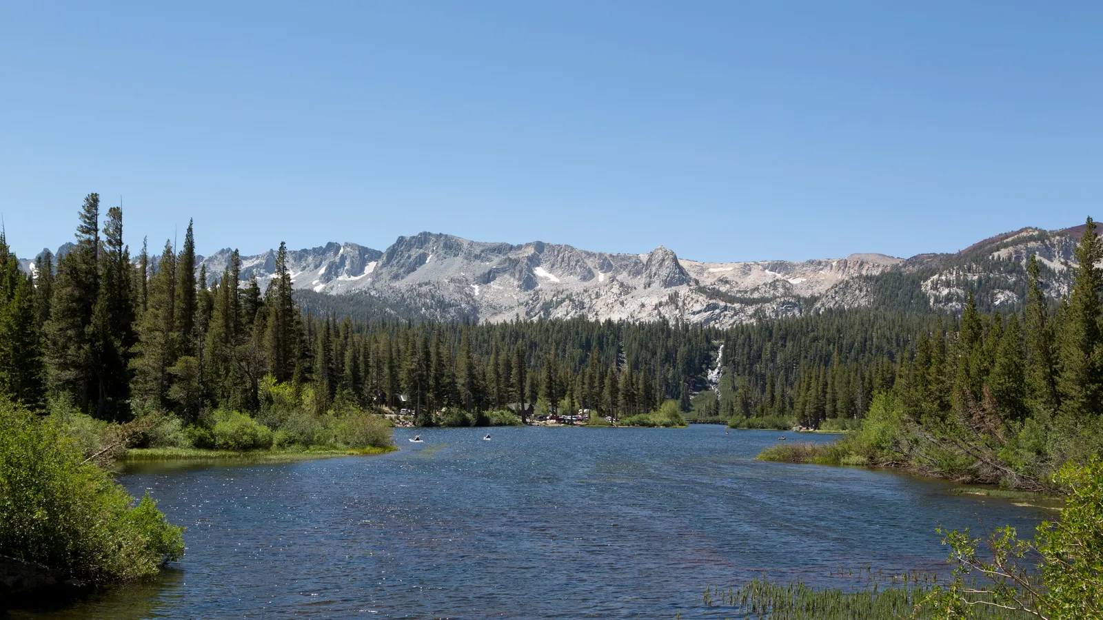 Twin Lakes winding through pine forest below the granite Mammoth Crest