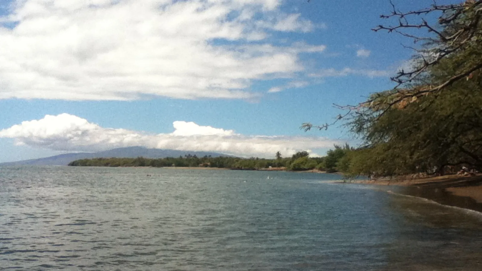 Calm, shallow water along the beach at Olowalu on Maui's west side, with Lanai on the horizon