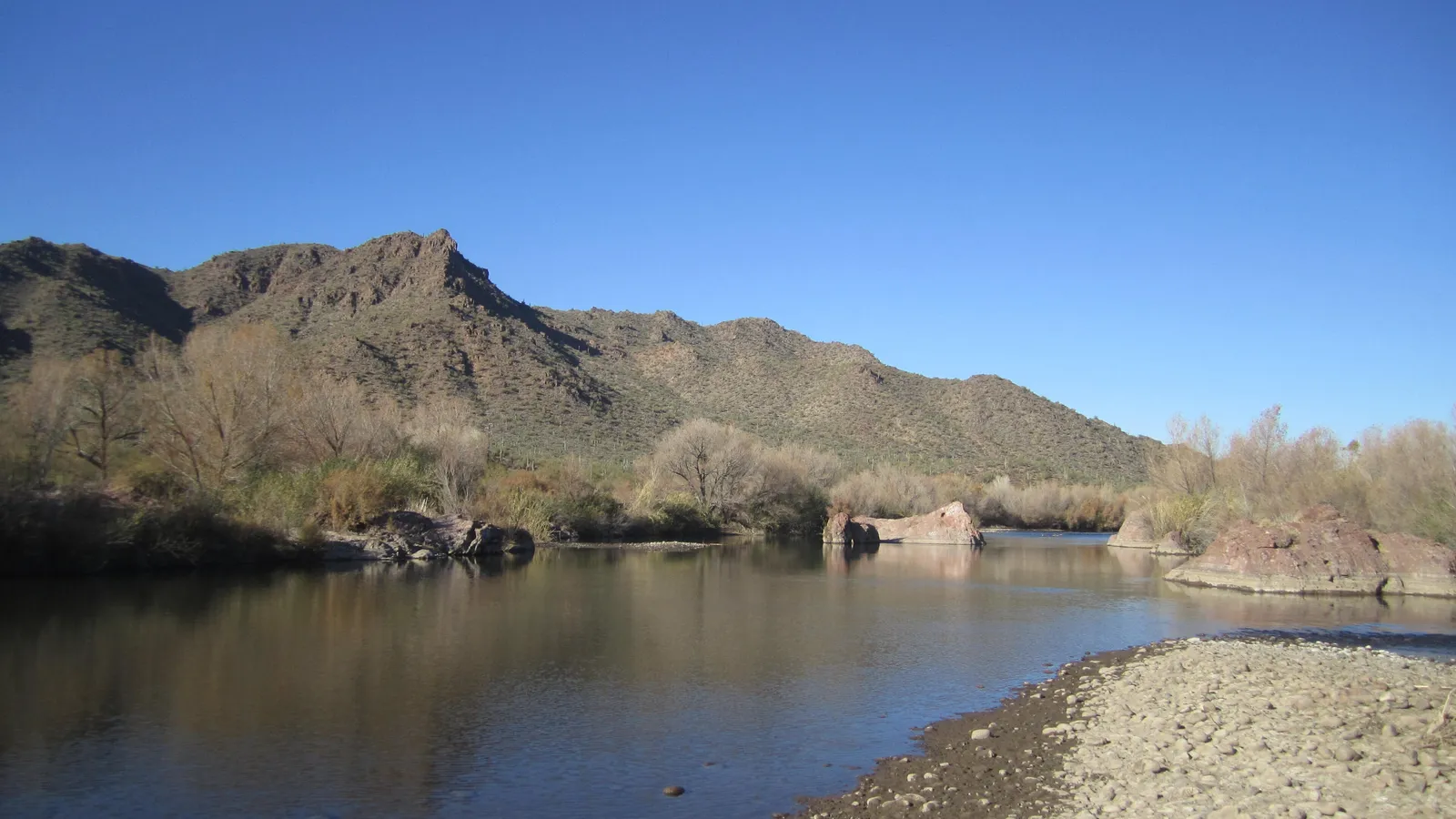 The Lower Salt River flowing past rocks and desert hills