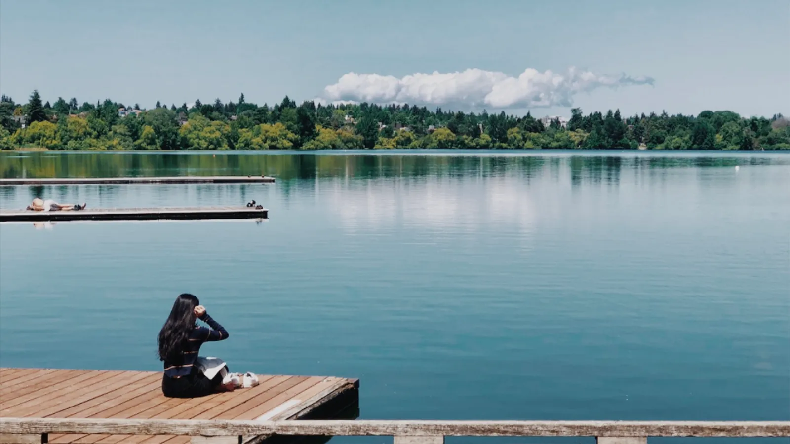 Still water and a wooden dock on Green Lake, Seattle