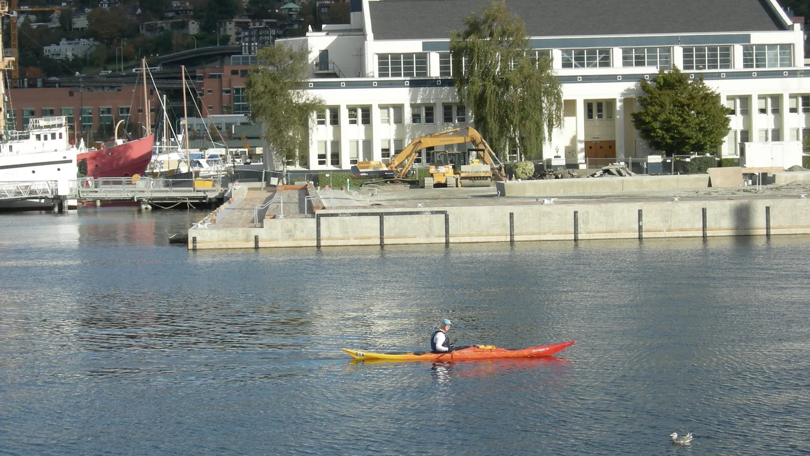 A kayaker paddling past the historic ships wharf at the south end of Lake Union