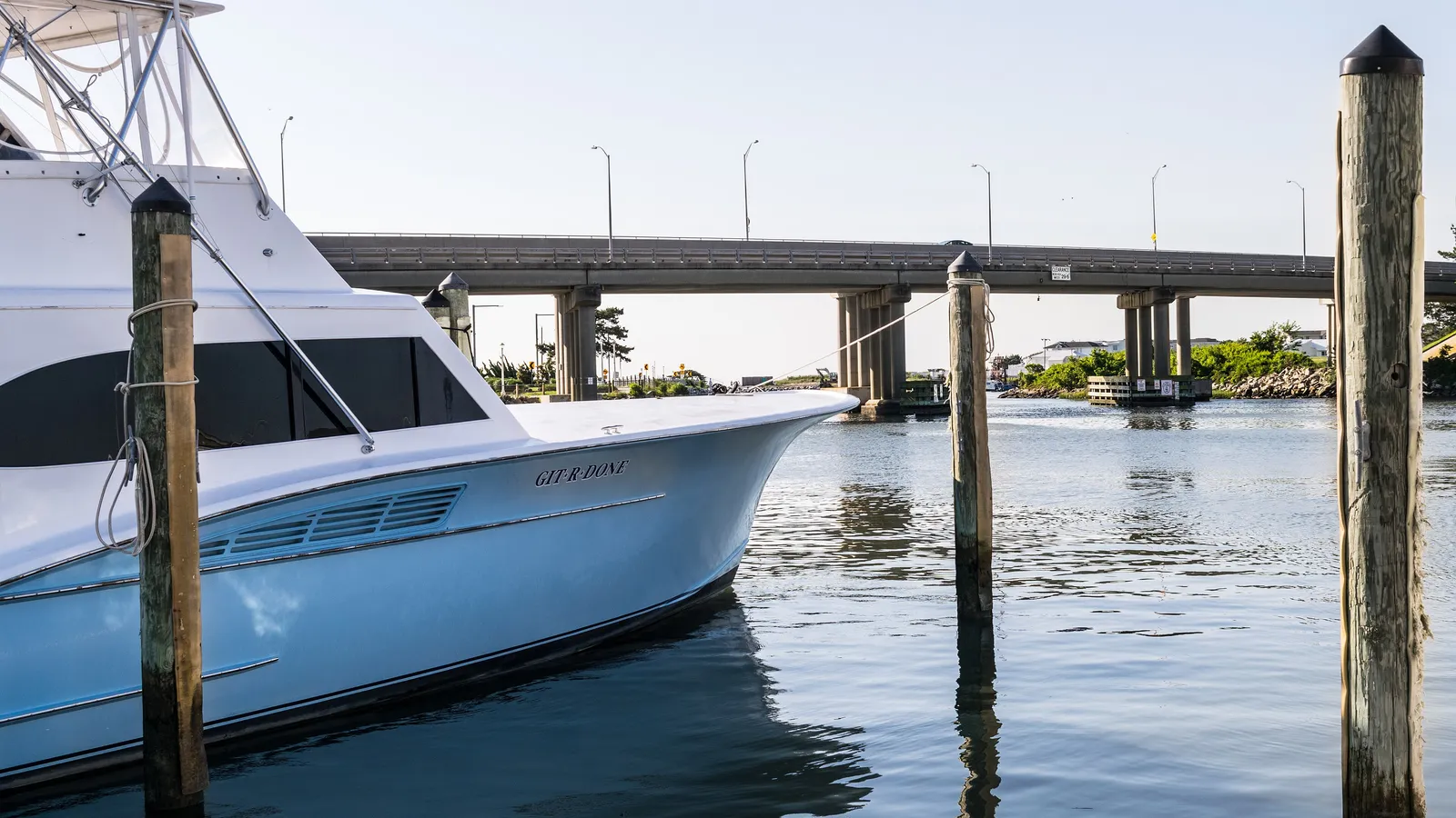 A sportfishing boat docked below the Rudee Inlet bridge