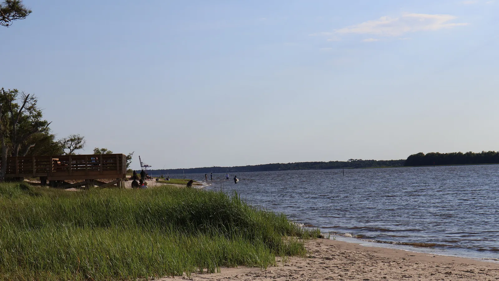 A small sandy beach and marsh grass beside the water at Carolina Beach State Park