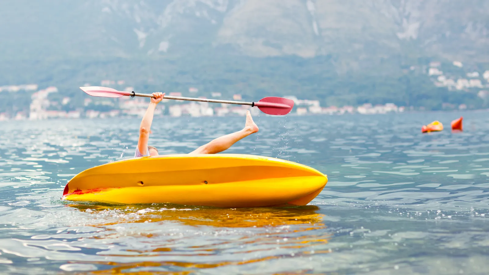 Kayaker tipping over while trying to balance