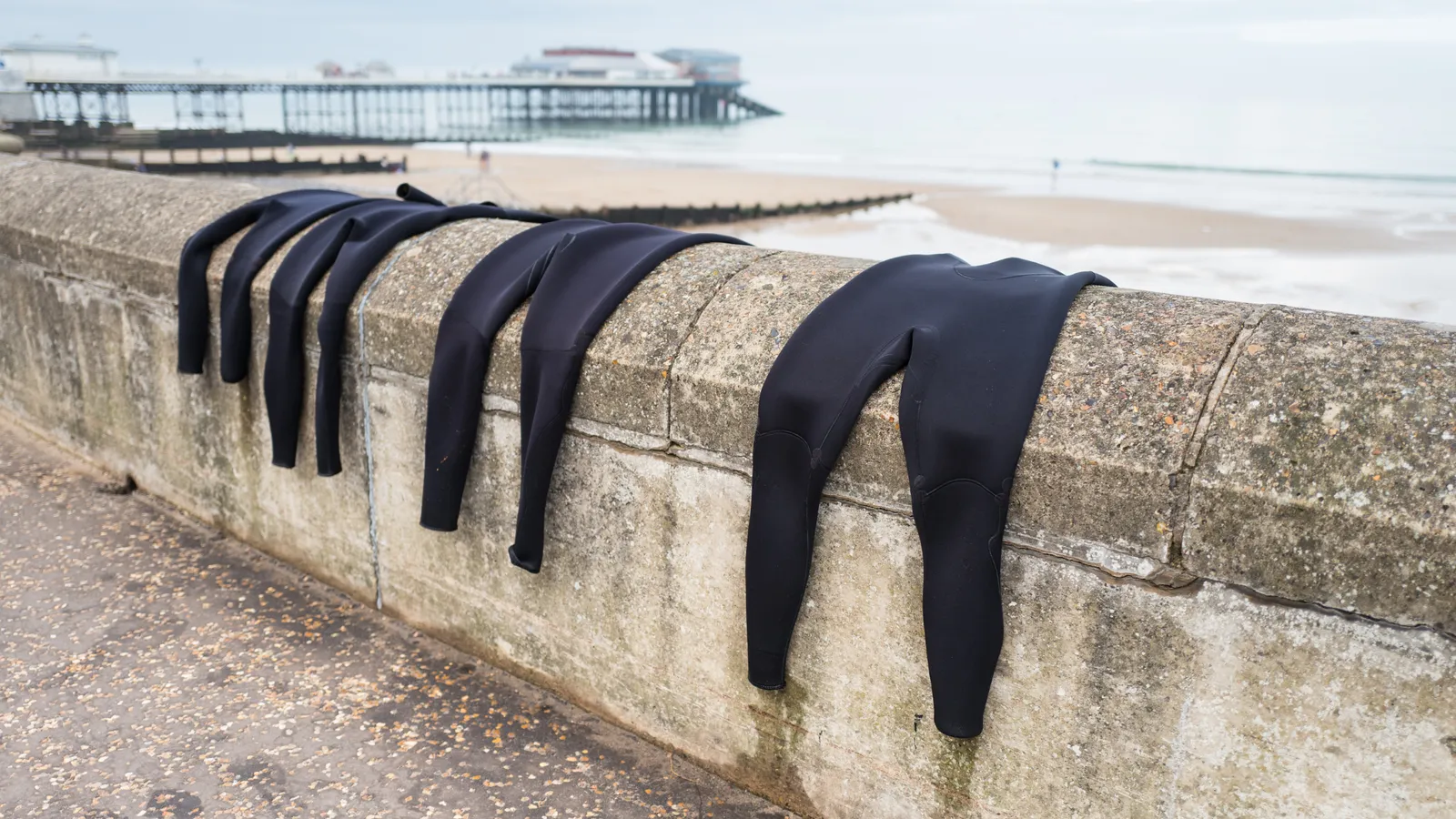 Wetsuits laid out for paddleboarding