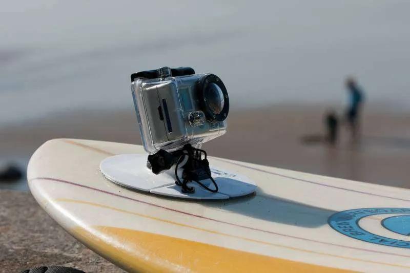 GoPro surfboard-style adhesive mount on the front of a board