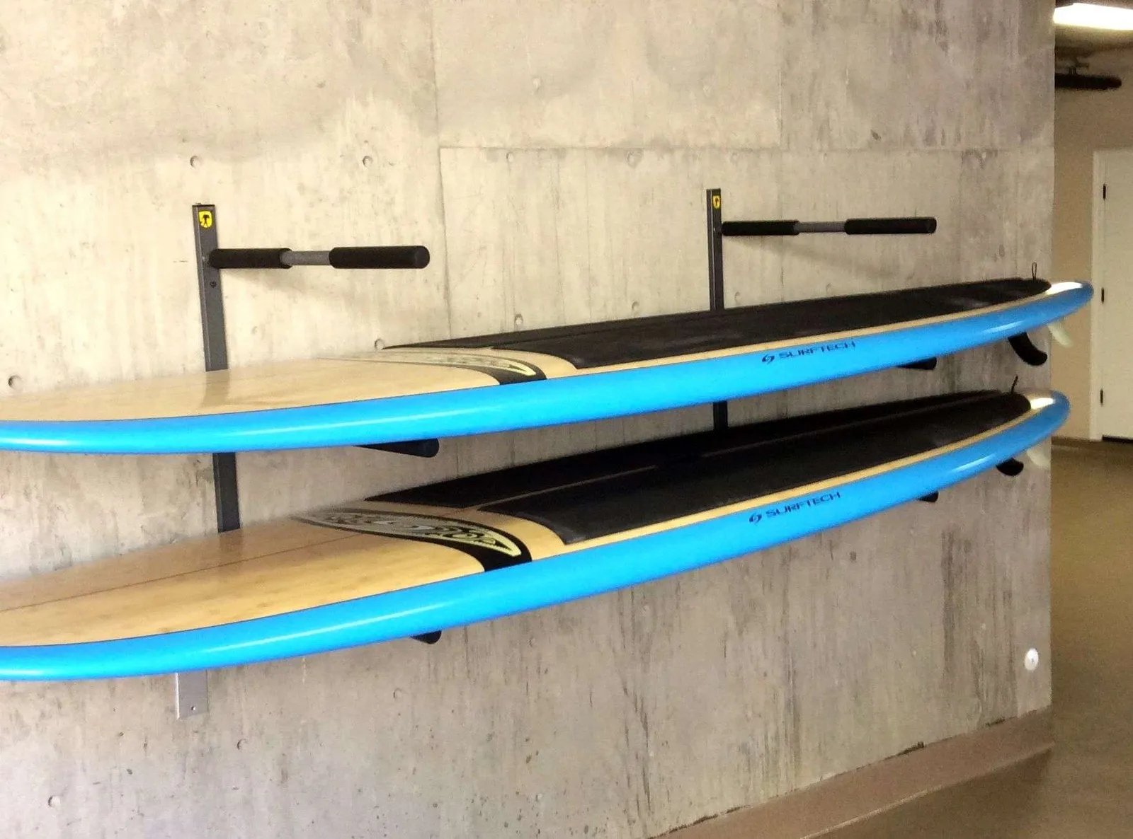 Paddle board stored indoors on a wall rack