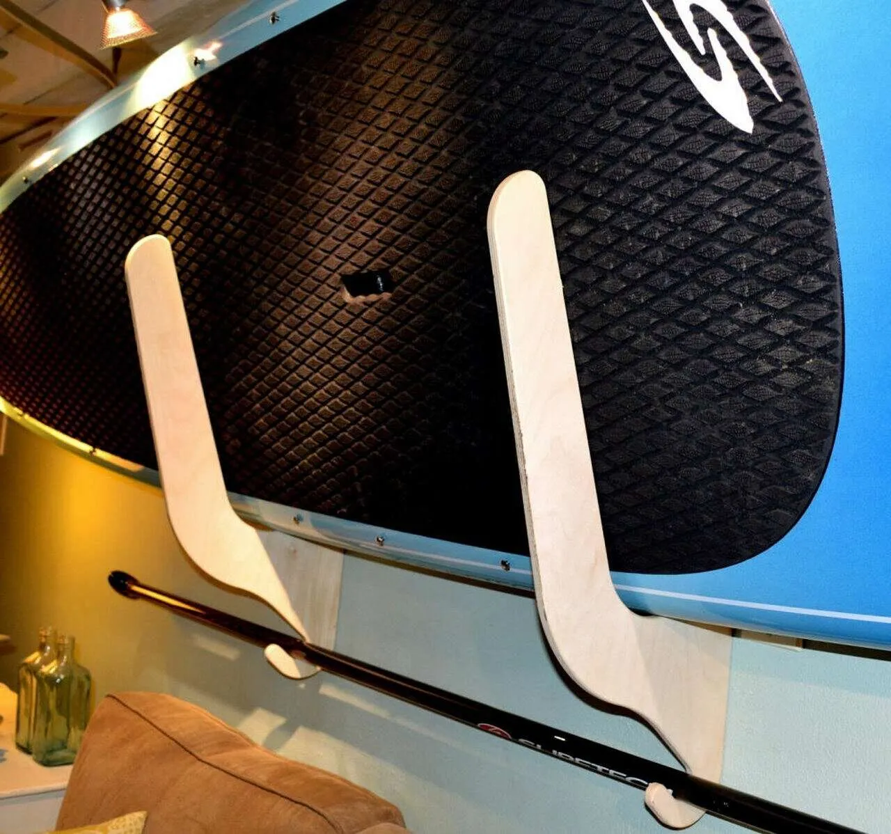Paddle boards on a padded storage rack