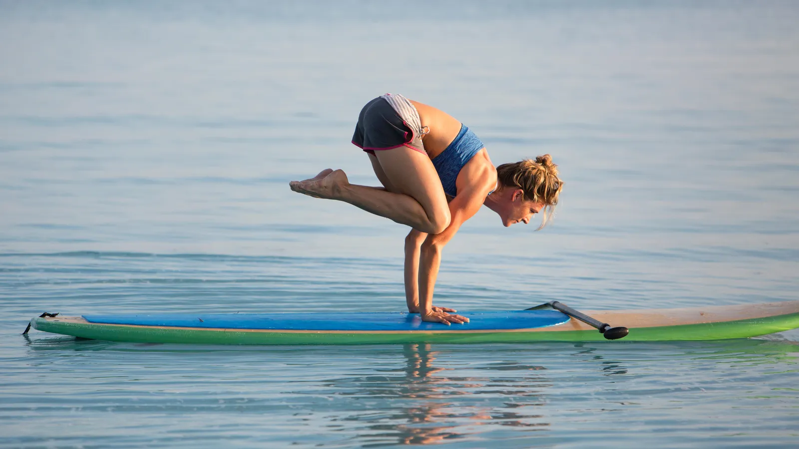 Advanced paddle board yoga pose
